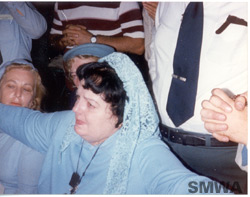 Photo of Veronica in ecstasy extends her arms in the form of the cross as she views the agony of Jesus on the cross